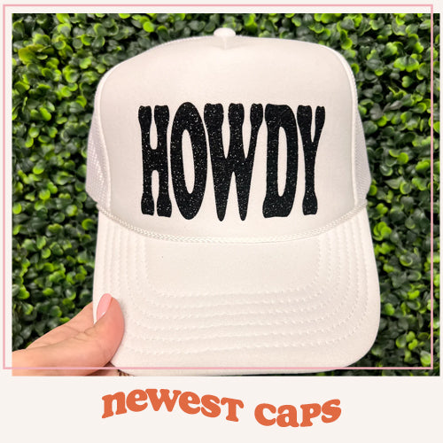 Shop our trucker cap collection. Shown is our black glitter Howdy cap.